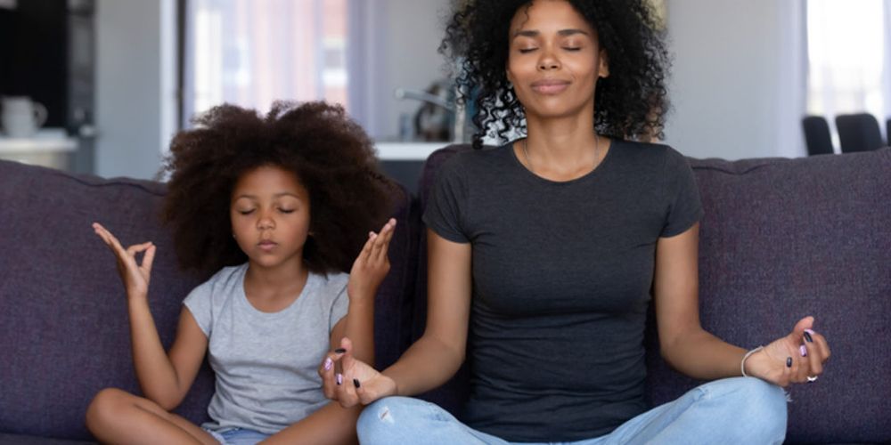 mother and daughter meditating
