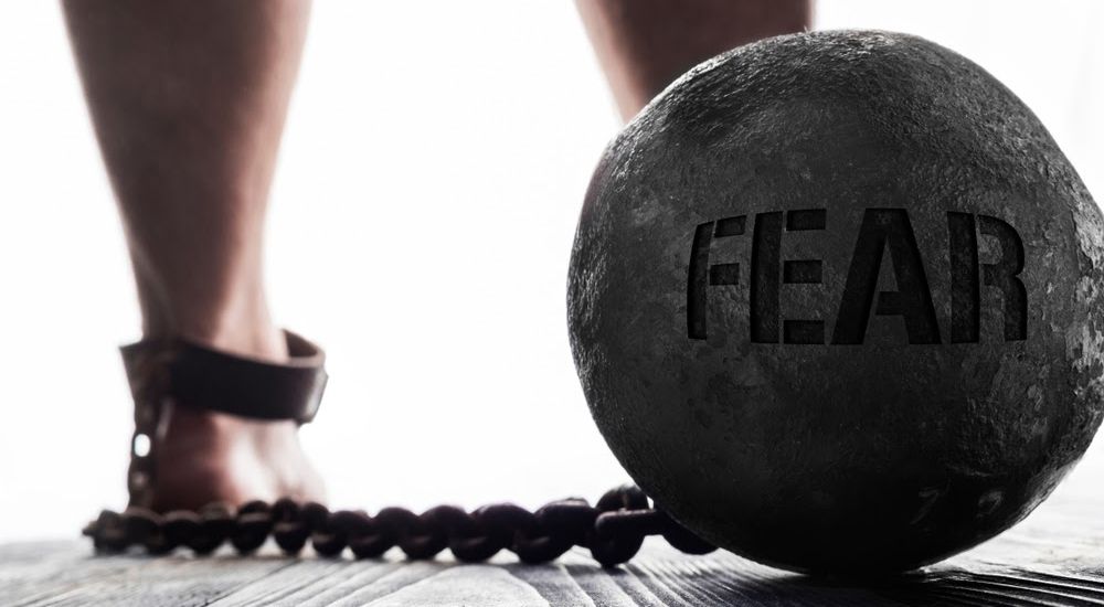 weighted ball with the word fear ingrained in it