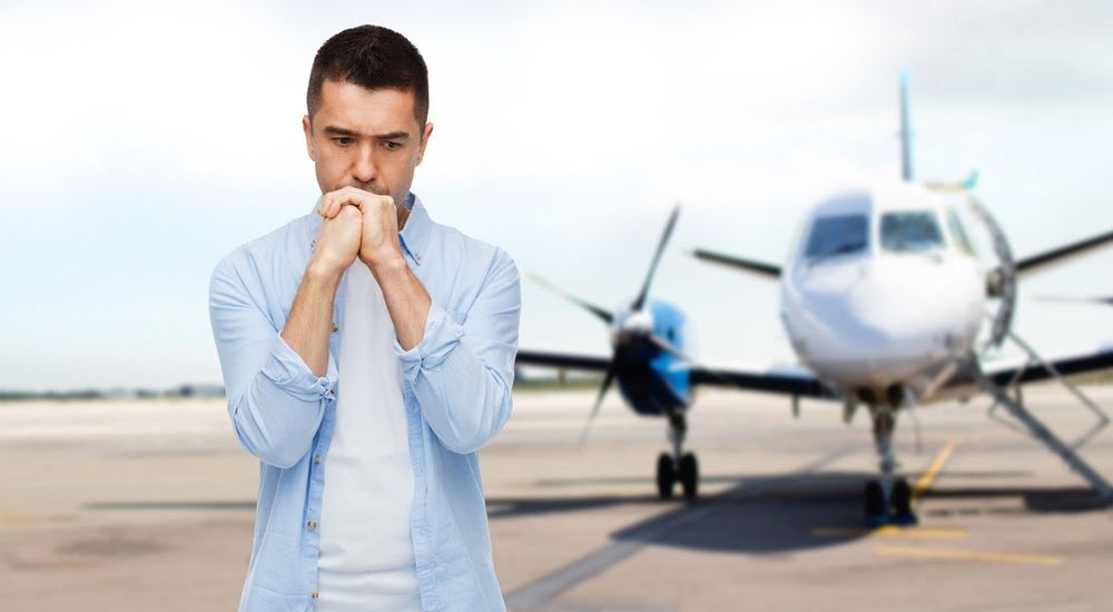 man nervous in front of plane