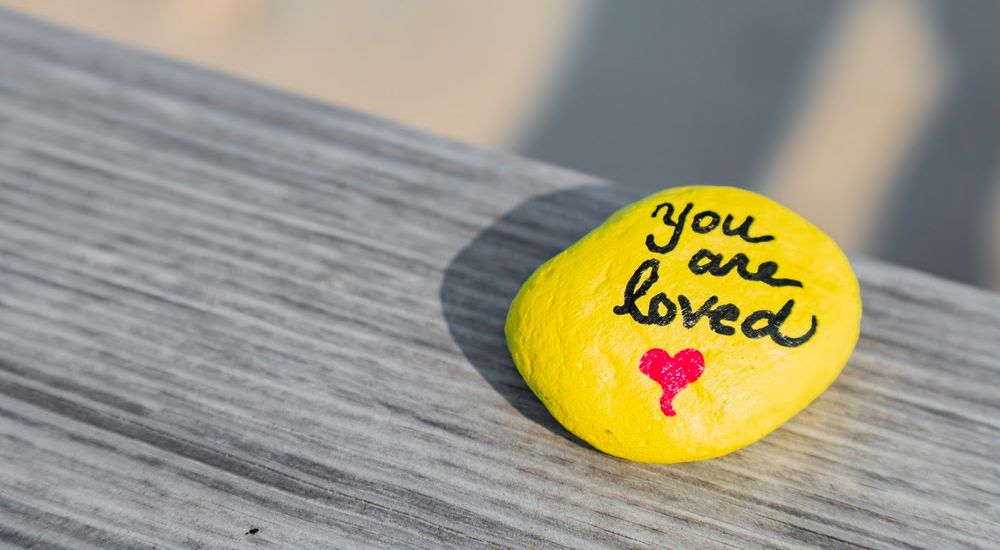 rock with words you are loved written on it